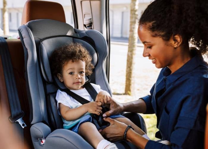 Woman Using Proper Child Safety Restraint