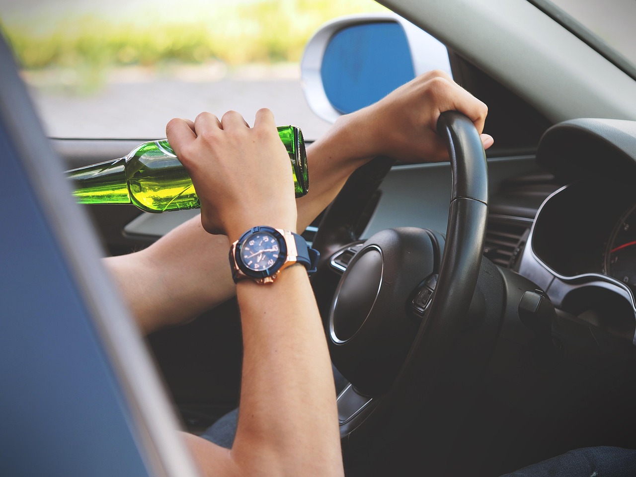 a man drinking and driving