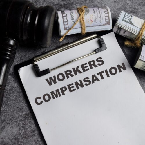 Concept of Workers compensation write on paperwork isolated on Wooden Table.