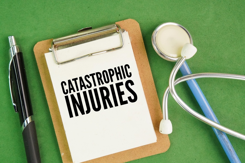 Stethoscope, pen and paper board with word catastrophic injuries. severe, life-altering injuries resulting in permanent disability, significant disfigurement